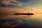 Sunrise seascape. Mountains and Agung volcano. Traditional gazebos on an artificial island in the ocean. Water reflection. Sanur