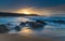 Sunrise Seascape with Streaky Clouds , Rocks and Blue Sea