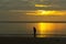 Sunrise with shadow fisherman in beach
