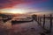 Sunrise Single Boat and Boatshed with Burning Sky.