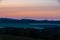 Sunrise in spring time with the silhouette of the typical Tuscan Poplar trees in a line alongside a road during the golden hour