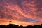 Sunrise with Street Lamp and House Roofs Silhouetted