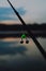 Sunrise or sunset fishing. Fishing rods on the background of the lake. Sports fishing. The bell hangs on a fishing line. selective