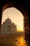 Sunrise of Taj Mahal through an archway in Agra India shot in high iso.