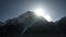 Sunrise timelapse. Bright sun ascend, aurora, radiance over snow mountain summit