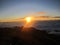 Sunrise at the top of Mount Rinjani in Lombok Island, Indonesia. View of crater lake covered in clouds from the summit. Beautiful