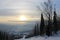 Sunrise on top of a mountain with slopes for skiers, snowboarders