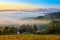 Sunrise, town and mountains in the fog, beautiful landscape