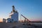 Sunrise Train Passing a Grain Elevator