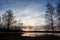 Sunrise and trees at lakeside