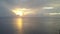 Sunrise on the tropical sea. Aero shooting from the drone, the coast with palm trees, the sun to shine through clouds