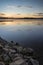 Sunrise vibrant landscape of jetty on calm lake