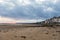 Sunrise view of coastal street of Grandcamp Maisy, a scenic French coastal town in Normandy, with fishing port, sandy