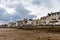 Sunrise view of coastal street of Grandcamp Maisy, a scenic French coastal town in Normandy, with fishing port, sandy