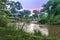 Sunrise view of Ishasha river, with trees growing and the reflections on the water, Queen Elizabeth National Park, Ishasha