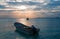 Sunrise View of Mexican Fishing Boat and ponga / skiff in Puerto Juarez Harbor of Cancun Bay