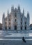 Before sunrise view of Milano Duomo Cathedral with pigeons in Milan, Italy