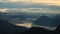 Sunrise view from Mount Brienzer Rothorn. Mount Stanserhorn and sea of fog on a cloudy summer morning