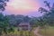 Sunrise view of a path to a wooden hut amongst green trees, Queen Elizabeth National Park, Ishasha, Uganda