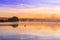 Sunrise view of a still, silent dam with boat jettyâ€™s in the foreground,  Club Elani Resort