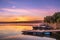 Sunrise view of a still, silent dam with boat jettyâ€™s in the foreground,  Club Elani Resort