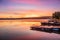 Sunrise view of a still, silent dam with boat jettyâ€™s in the foreground,  Club Elani Resort