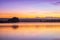 Sunrise view of a still, silent dam with boat jettyâ€™s in the foreground,  Club Elani Resort