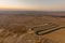 Sunrise view of winding road and Makhtesh Ramon, Negev Desert