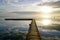 Sunrise wood pontoon in water reflection sunset sun in lake mirror image