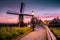 Sunrise Zaanse Schand Dutch windmill village, Windmill village Zaanse Schans, green wooden house at the windmill village