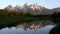 sunrise zoom in view of grand teton and a stream schwabachers landing in grand teton national park