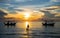 The sunrises above the tropical sea and the fisherman`s boat shadow is at the beach, Hua Hin, Prachuap Khiri Khan, Thailand