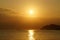 Sunrises in between Kaohikaipu (Black/Turtle) Island and Makapuu with sunlight reflecting on the ocean water of Waimanalo bay