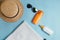 Sunscreen bottle,  sun hat, cream, lotion bottle, various sunscreens and seashells on a blue background. summer. vacation. Sun pro