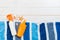 Sunscreen bottles with starfish and blue towel on white wooden table with copy space. Travel healthcare accessories top view