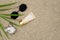 Sunscreen, glasses, shell, palm leaf on sand