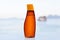 Sunscreen in luxurious bottle on beach.