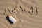 Sunscreen protection lotion in the sand on a sunny day at the beach. White sunblock cream protection bottle from sunburn. Nobody