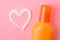 Sunscreen remedy. various sunscreens and a cream heart against a bright pink background. Sun protection. Ultraviolet protection. S