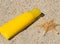 sunscreen tube on beach sand