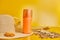 Sunscreen tube mockup with shells, sand yellow background