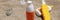 Sunscreens in colourful unbranded bottles on sand