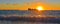 Sunset above the Adriatic sea in summer with cargo ship