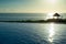 Sunset above palm leace shelter with view to endless Atlantic ocean, Cayo Guillermo, Cuba