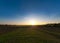 Sunset aerial view: Aerial Journey Over a Tranquil Farm Field