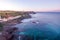 Sunset aerial view of the coastline of Portopalo and the Tafuri castle, Sicily, Italy