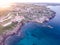 Sunset aerial view of the coastline of Portopalo and the Tafuri castle, Sicily, Italy