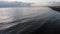 Sunset aerial view over swollen silky sea water and  beach at Rome coastline