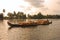 Sunset, agricultural Harvest of burlap or gunny sack probably full of rice on Wooden Boat in Alleppey Alappuzha, Kerala, India