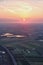 Sunset from an airplane view with fields and lakes